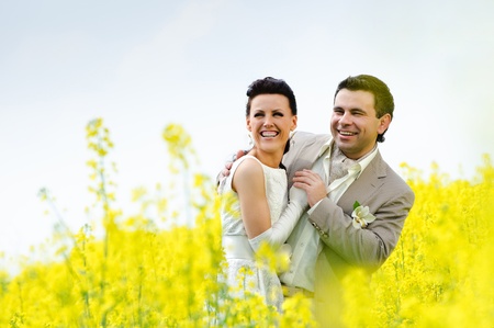 newly-married couple in a rape fieldの写真素材