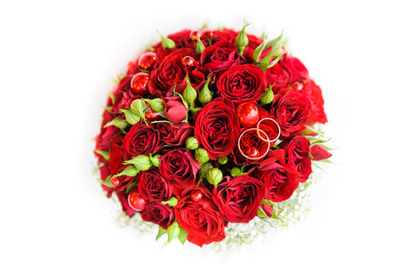 Wedding rings on a bouquet of rosesの写真素材