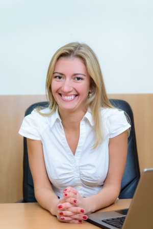 Smiling confident businesswoman with a laptop.の写真素材