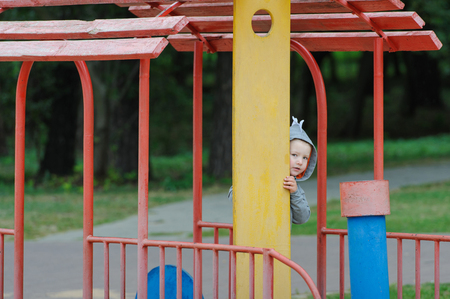Little boy peeping on the childrens playgroundの写真素材