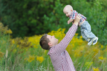 Happy young father lifting up his sonの写真素材