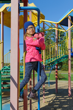 Little girl on outdoor playground equipmentの写真素材