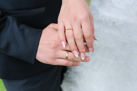 Holding Hands with wedding ringsの写真素材
