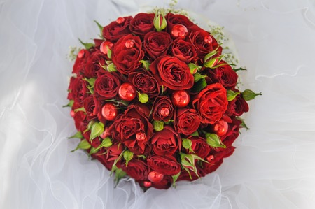 Wedding bunch bouquet of red roses on the veilの写真素材