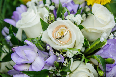 Wedding rings on wedding bouquetの写真素材
