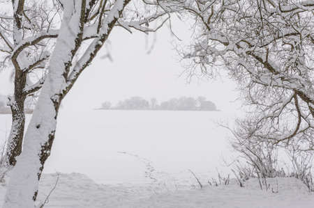 Silhouette of the island in cloudy foggy weather.の写真素材