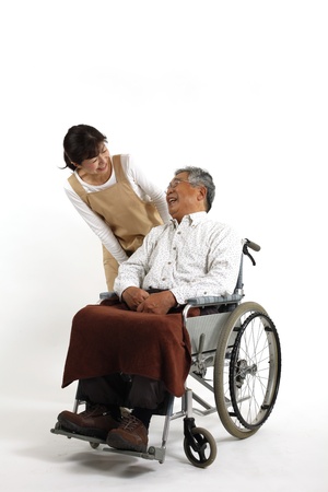 Old man who sat in a wheelchair with nurse careの写真素材