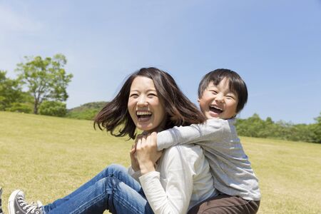 Japanese parents and children playing in the parkの写真素材