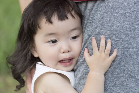 A little girl being heldの写真素材