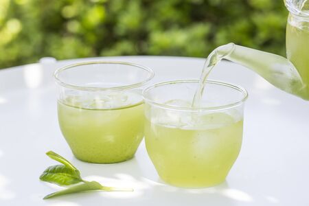 Cold green tea on the garden tableの写真素材