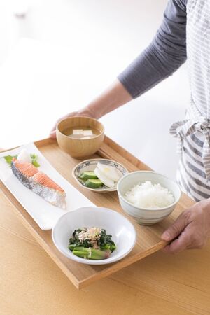 A woman carrying Japanese foodの写真素材