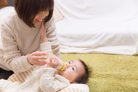 nfant drinking milkの写真素材