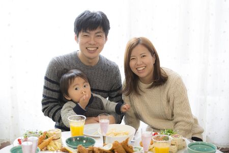 Christmas home party, Japanese parents and childrenの写真素材