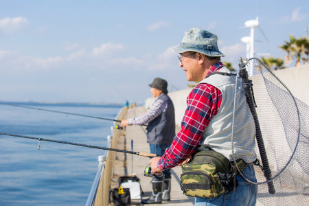 Senior Japanese men enjoying fishing