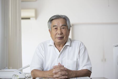 Japanese old man at home staringの写真素材