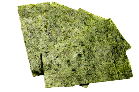 Pieces of seasoned dried seaweed isolated on whiteの写真素材