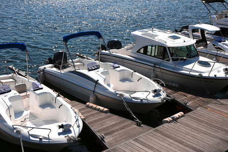 A pleasure boat lining the pier of the marinaの写真素材