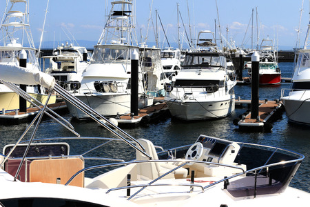Luxurious summer view of the marina with a stylish cruiser mooredの写真素材