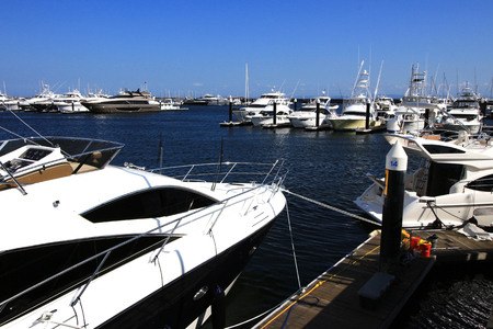 Luxurious summer view of the marina with a stylish cruiser mooredの写真素材