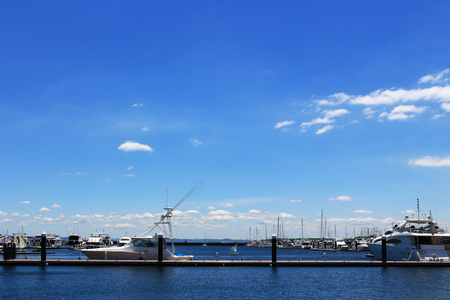 Luxurious summer view of the marina with a stylish cruiser mooredの写真素材