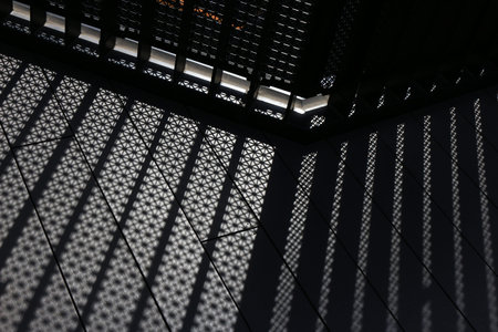 White light passing through a geometric pattern fence