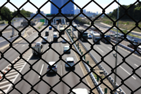Wire mesh surrounding highwayの写真素材
