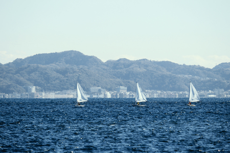 Small yachts practicing in winter seasの写真素材