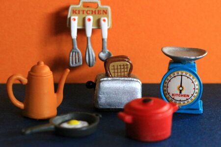 Cookware figures lined up in a colorful kitchenの写真素材