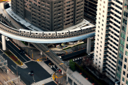 A diorama style photo of the "Yurikamome" train on the Tokyo New Waterfront New Transit Rinkai Line, which runs through an apa rtment complex district in central Tokyoのeditorial素材