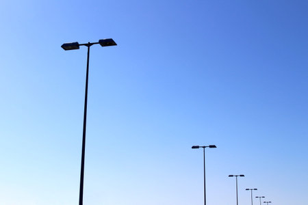 Highway street lights lined under the blue sky
