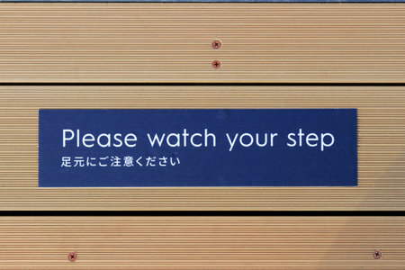 Wooden stairs with the words please watch your step