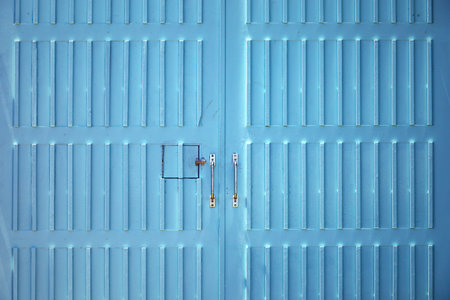 Wooden garage door with bright turquoise as a background materialの写真素材
