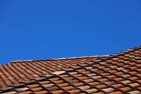 Terracotta tile roof and clear blue skyの写真素材