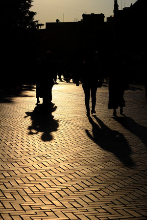 Daily Life in Japan "Silhouettes of people walking through the city illuminated by the setting sun"の写真素材