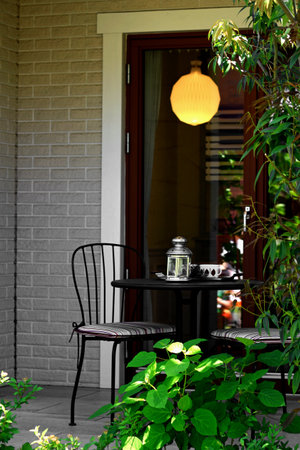 A small terrace of a house and an empty cafe tableの写真素材
