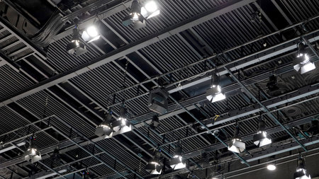 A large studio ceiling rig with exposed structure and many hanging spotlights