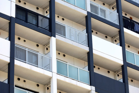 The modern apartment building exterior of the colored in white and navy blue