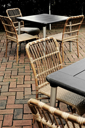 Cafe tables lined up in a brick courtyardの写真素材