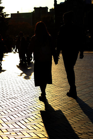 Everyday scenes in Japan Silhouette of a couple walking through the city in the sunlight at dusk