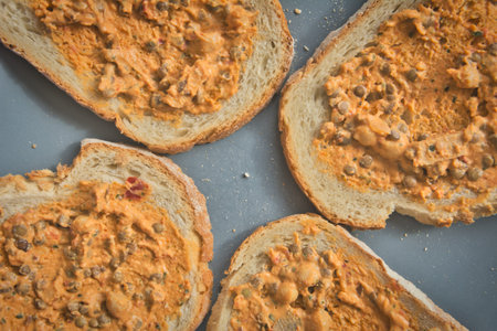 Plate of bread with lentil salad spread. Simple vegetarian or vegan lunch.