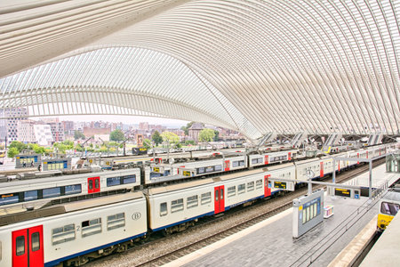 Liege, Belgium, June 2021: Indoor scene of the Train station of liege guillemins with railroad platforms and trains waiting for departureのeditorial素材