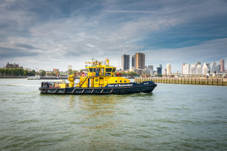 Rotterdam, Netherlands, September 2019: port authority vessel on patrol in the harbor at Wilhelminapier. Skyline of Rotterdam in the backgroundのeditorial素材
