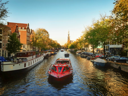 Autumn in Amsterdam: view on the tree-lined canal with boats on a sunny dayのeditorial素材