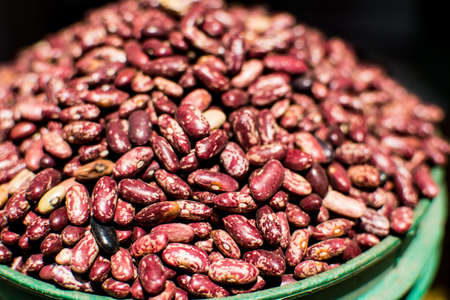 Bowl of red beans, piled up, in close-up and detail, with defocused backgroundの写真素材