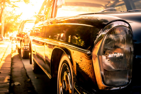 Side view of a Mercedes Benz W114, /8, stroke eight or Strich Acht, parked in the streets of Luang Prabang during golden hour or sunsetのeditorial素材