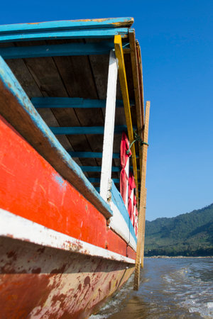 Close-up of a wooden river boat on the river Mekong in South-East Asia. Slow travel and tourism.のeditorial素材