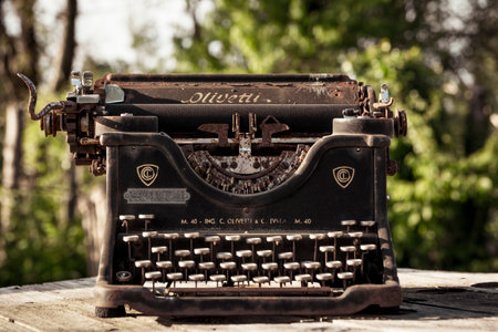 Ciney, Belgium, May 2022: Olivetti retro and vintage typewriter. Worn-out and rusty due to weather and outdoor conditions.のeditorial素材
