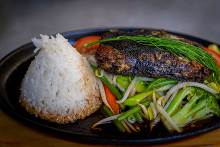 Vegan Vietnamese dish with rice, vegetables and seaweed burger. Horizontal close-up and selective focus. Healthy eating. No animal products food.の写真素材