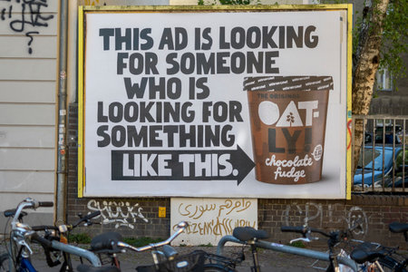 Berlin, Germany, June 2022, Illustrative Editorial: Big ad for Oatly plant based and vegan ice cream in the streets of a cityのeditorial素材