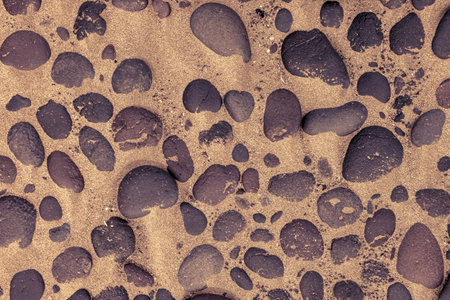 Directly above shot of lava stones in the sand of Famara beach in Lanzarote.の写真素材